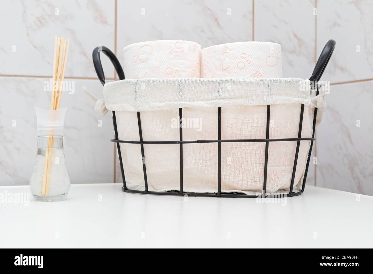 Soft toilet paper rolls in a vintage basket Stock Photo