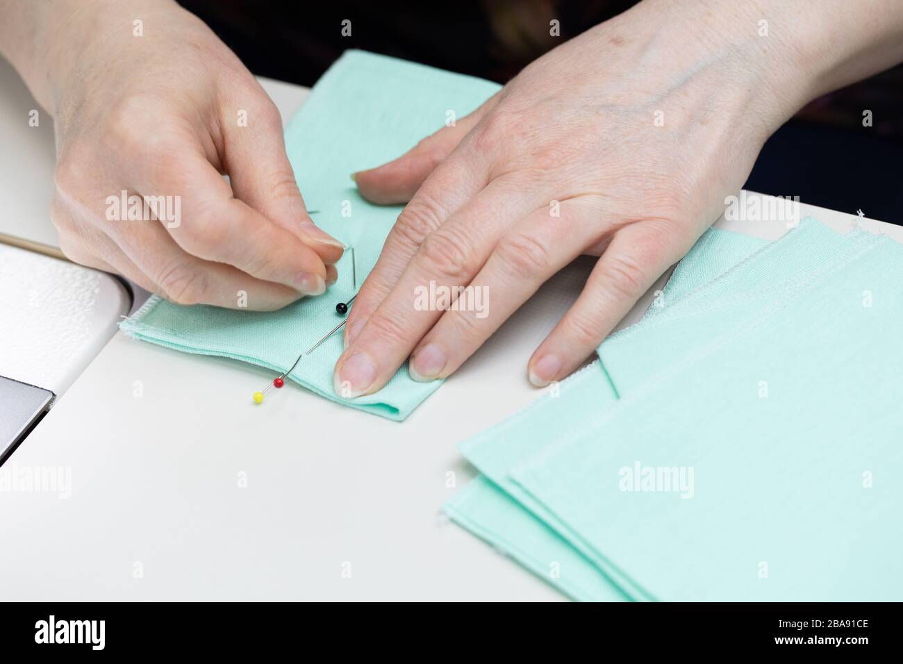 Marking pins to be sewn with a sewing machine Stock Photo Alamy