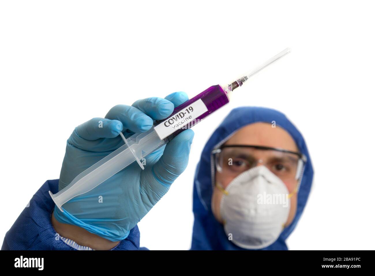 Doctor in protective mask and gloves holding syringe with virus COVID 19 vaccine. Stock Photo