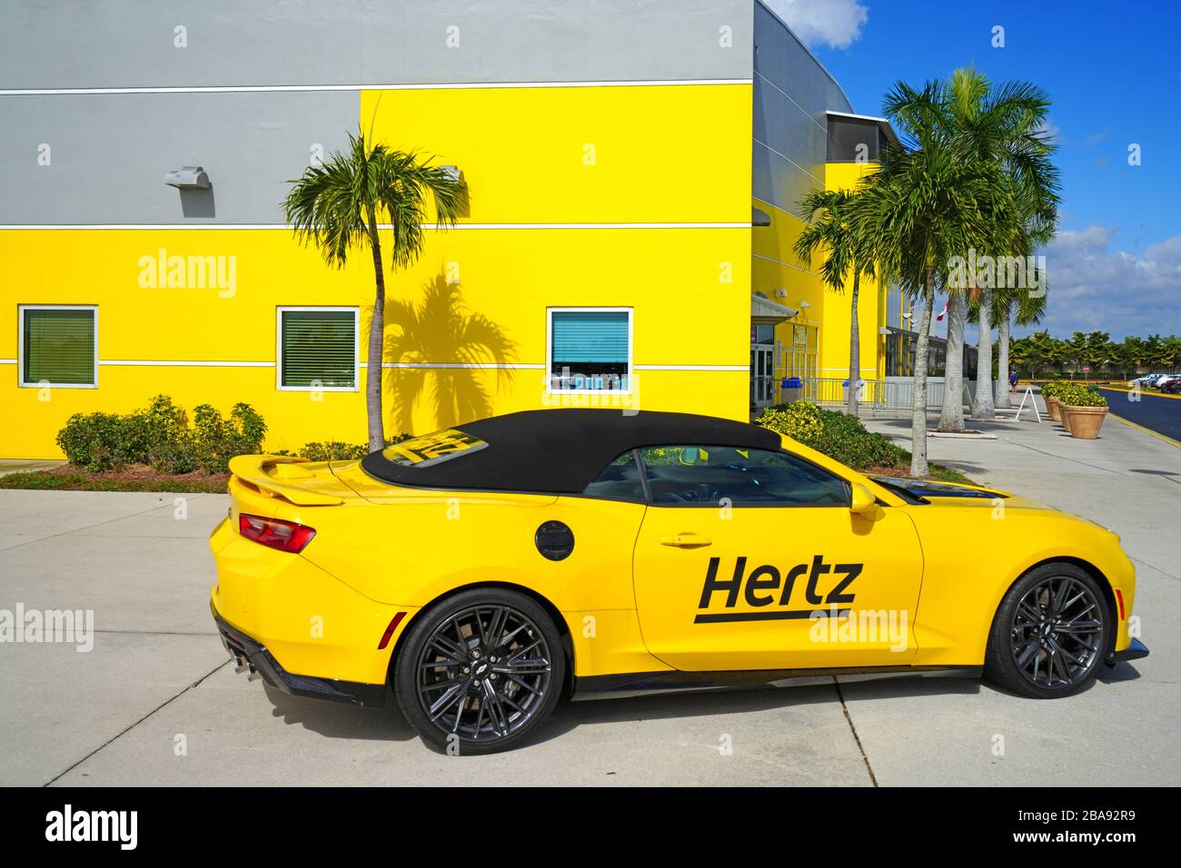 ESTERO, FL 30 JAN 2020 View of a yellow Hertz rental car in front of the Hertz Arena, a