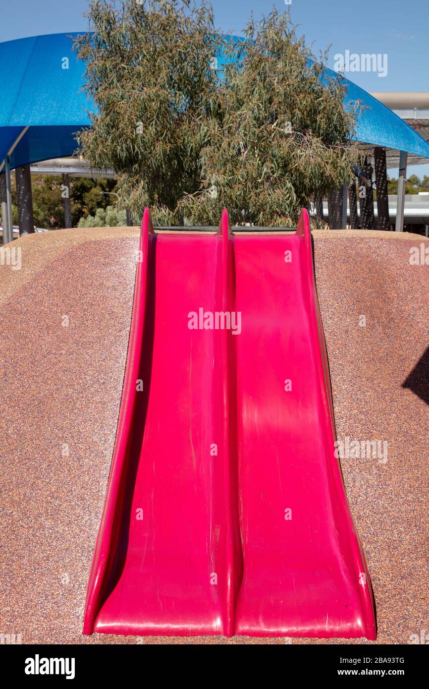 Playground with slide and soft surface material seen in the city of