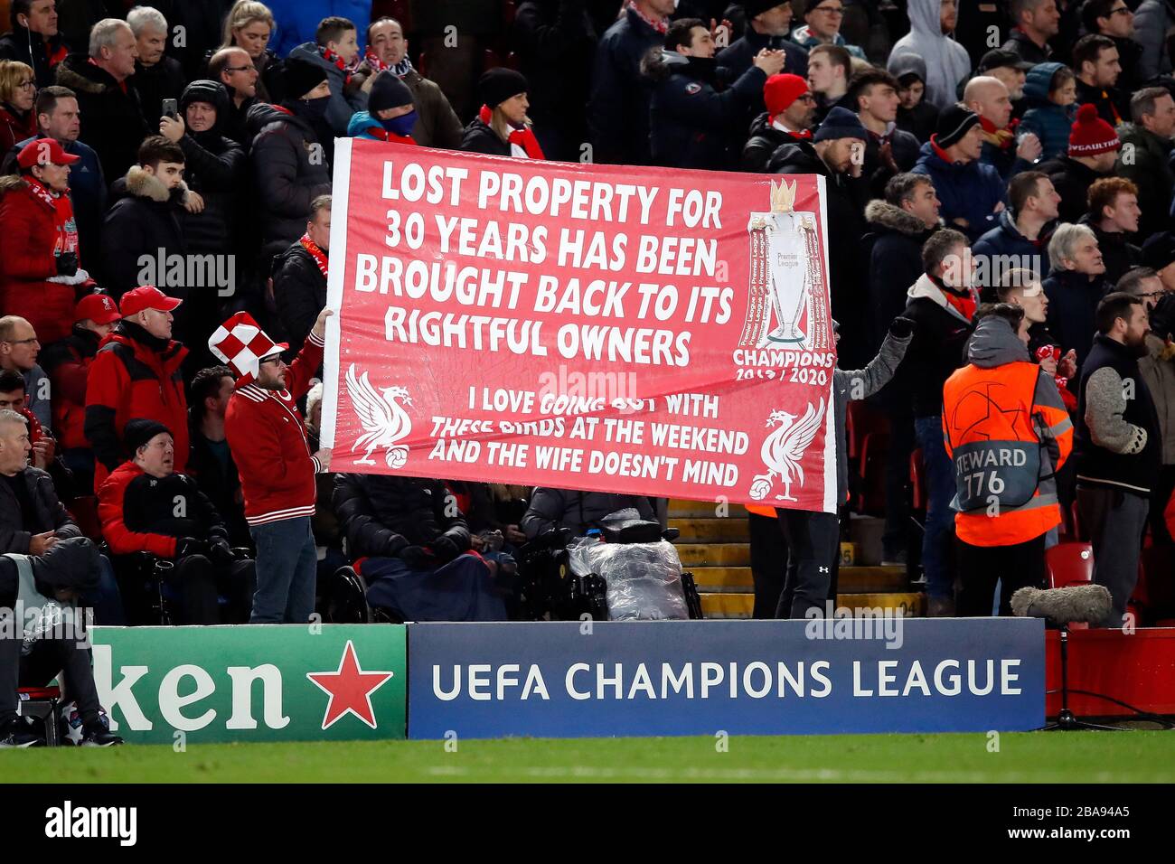 Liverpool fans hold a Champions League banner in the stands in support of their team Stock Photo