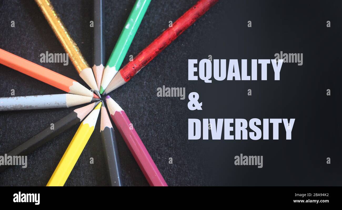 Colored pencils on a black background. Equality and diversity concept ...