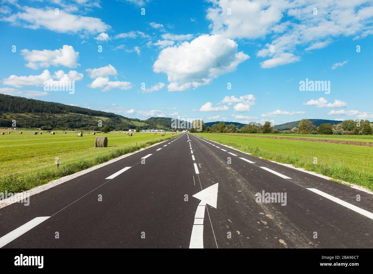 asphalt road through the green field and clouds on blue sky Stock Photo ...