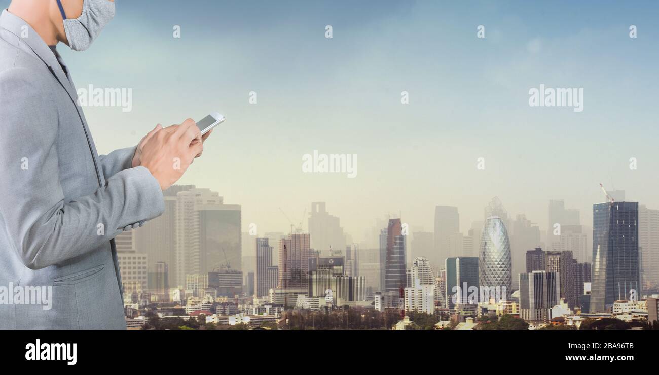 Businessman wearing a mask isolated on city background. Promoting people use face mask to protect themselves from virus infection in Corona virus cris Stock Photo
