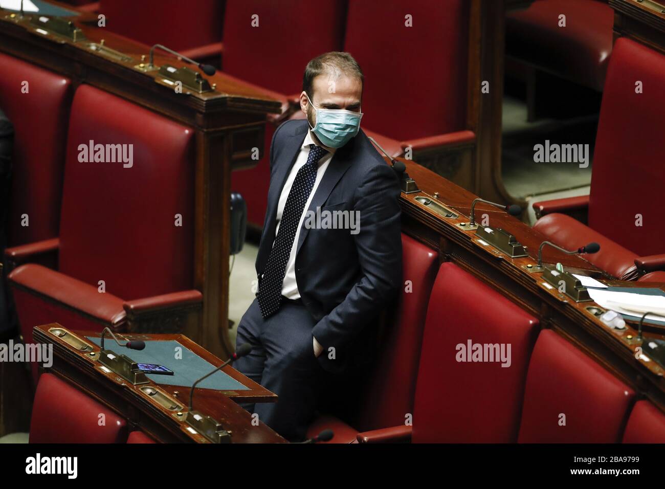 Italy, Rome, march 25, 2020 : Luigi Marattin (Democratic Party), wearing a protective mask and gloves, listens to the President of the Council Giusepp Stock Photo