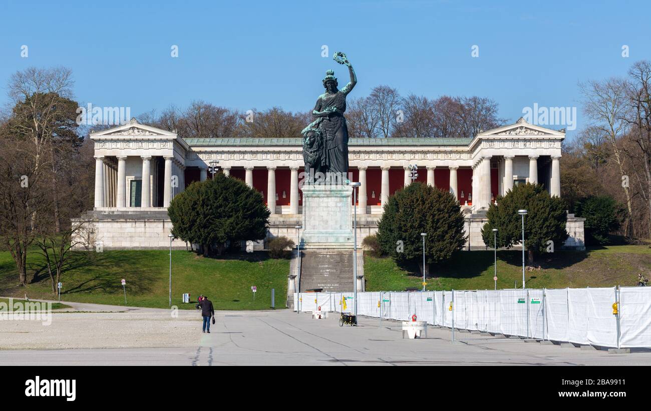 Panorama of Bavaria Statue & Ruhmeshalle (hall of fame) at Theresienwiese. The white fence belongs to a Coronavirus drive in testing station. Stock Photo