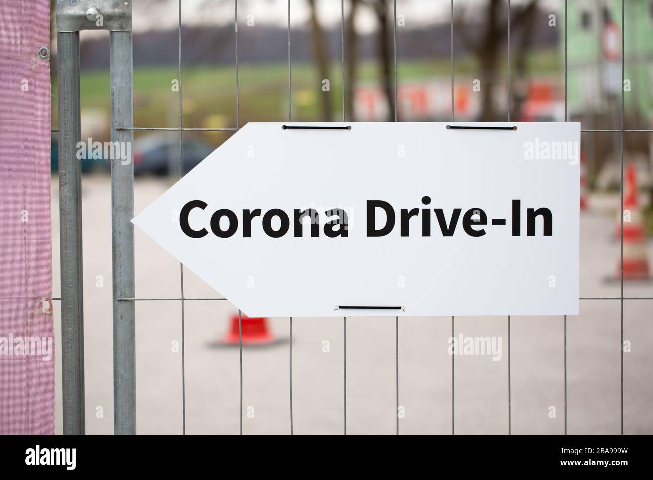 Close up of Corona Drive-In sign fastened on a fence. Leading to a Coronavirus Test Station. First cases of Covid-19 were diagnosed in 2019 in China. Stock Photo