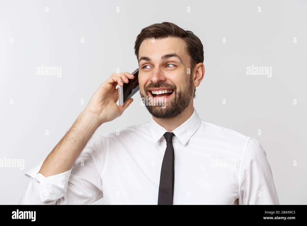 Young handsome business man calling using smartphone over isolated background with a happy face standing and smiling with a confident smile showing Stock Photo