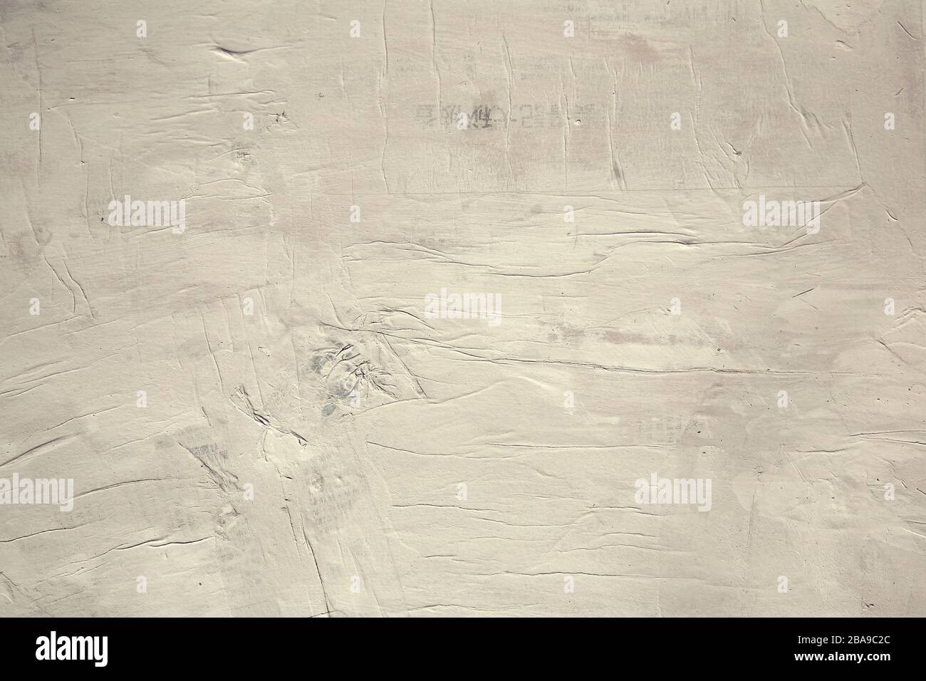 Background wall of Asian newspaper painted over in warm white paint Stock Photo