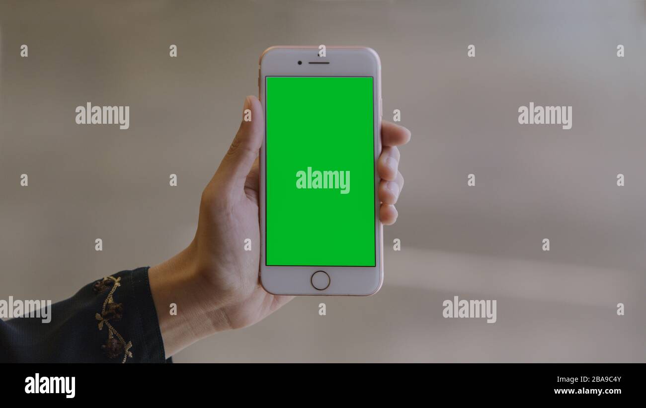 Woman using a smartphone (green screen) Stock Photo
