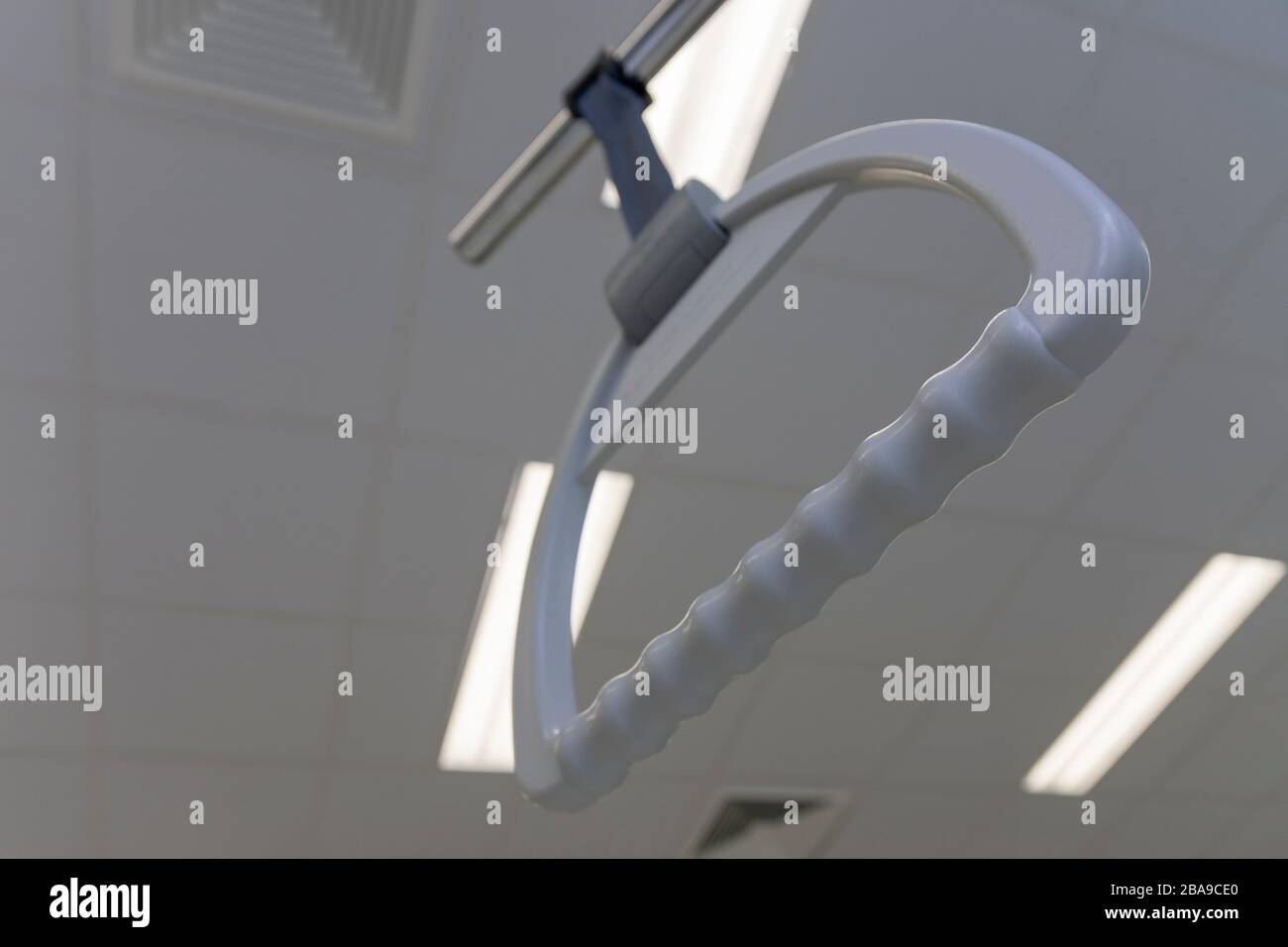 Hospital bed trapeze in intensive care unit in hospital, on background