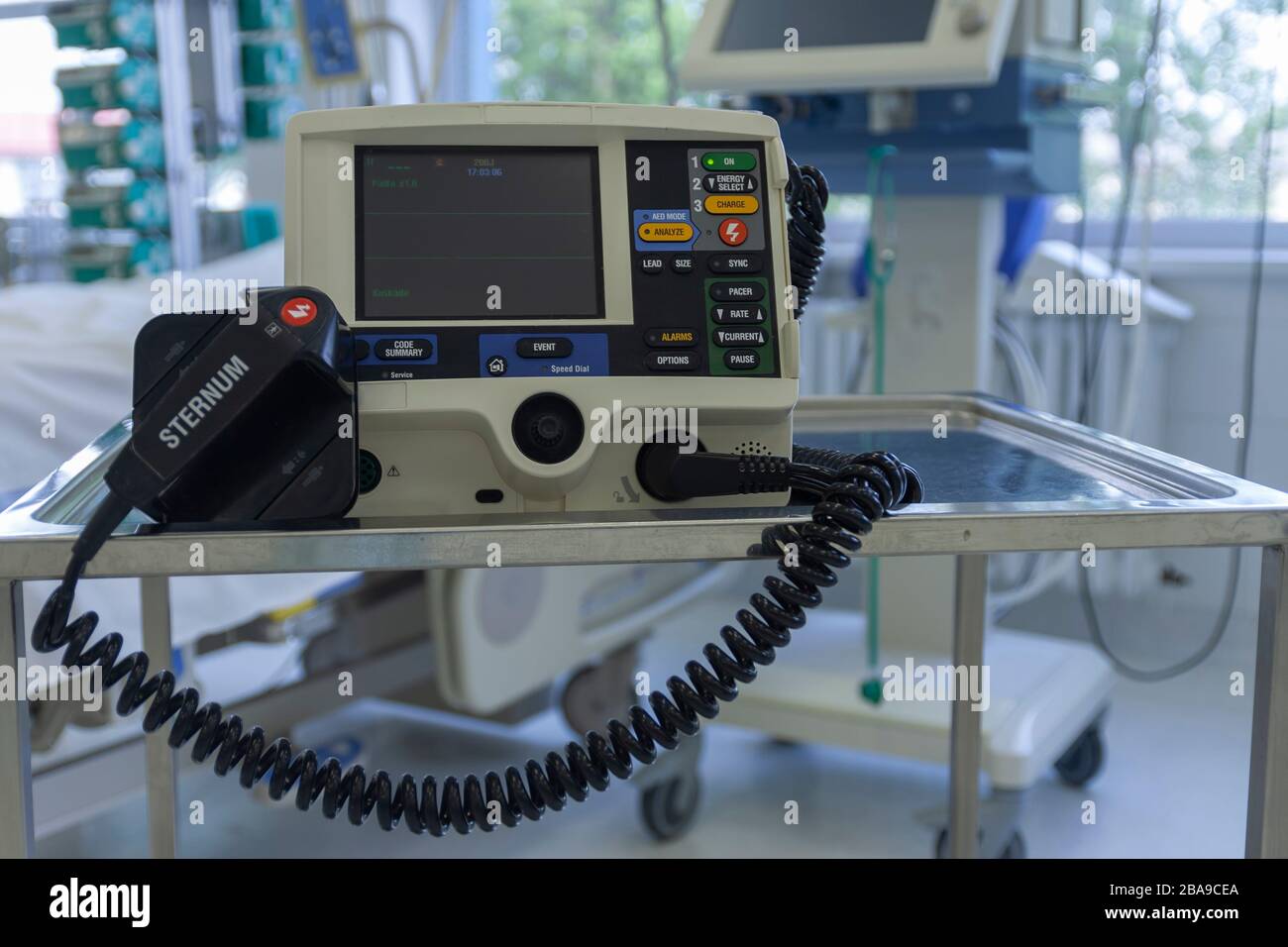 Defibrillator, on background medical ventilator in ICU in hospital, a