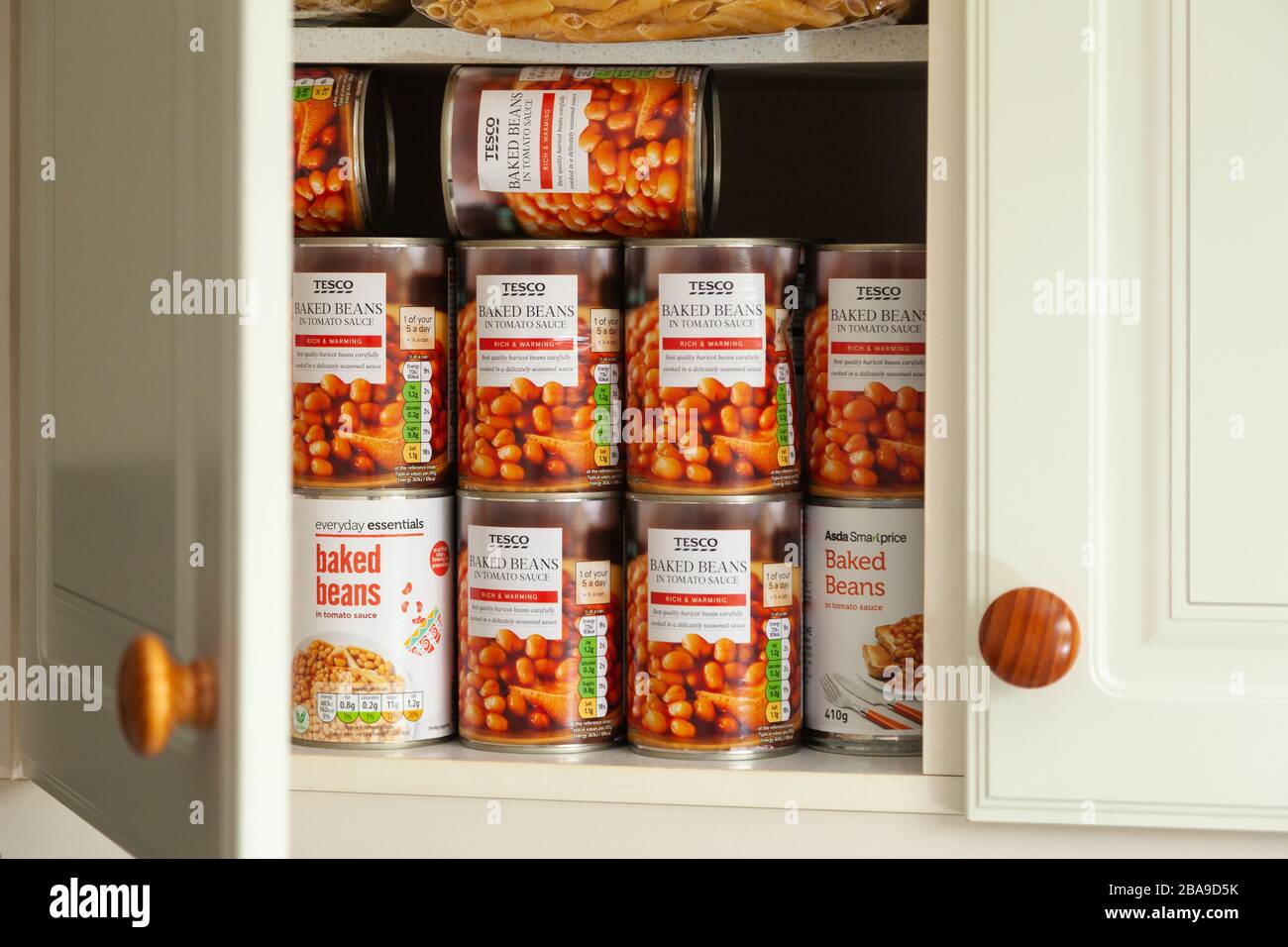 A cupboard full of stockpiled beans and pasta. Stock Photo