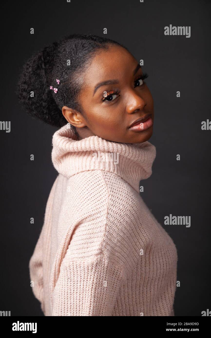 Portrait of a beautiful young woman wearing a woollen jumper Stock Photo