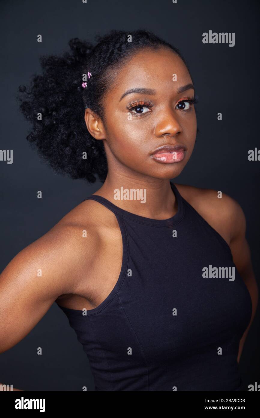 A beautiful black woman wearing a black top and looking at camera Stock ...