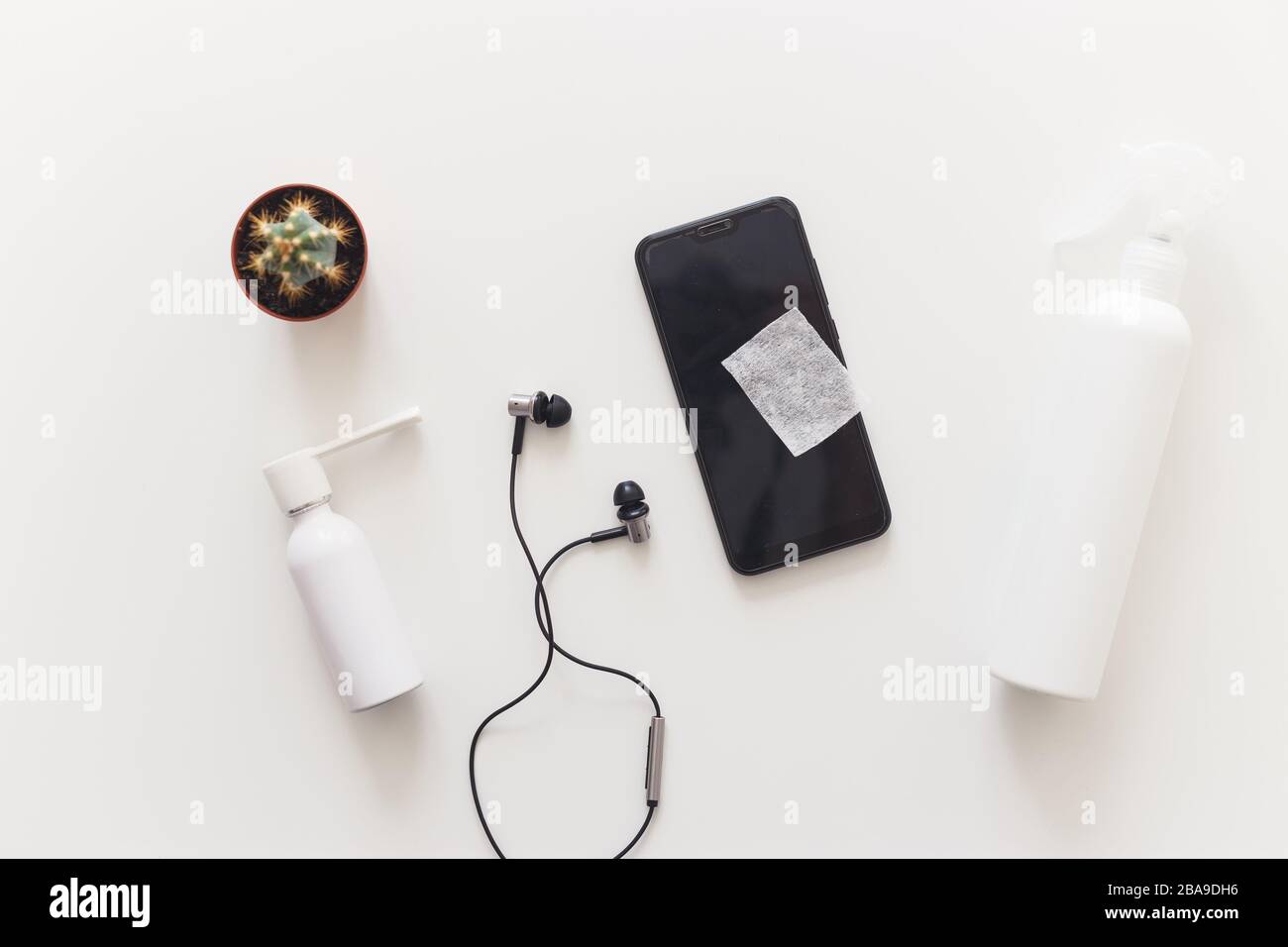 Man disinfects smartphone wiping by antibacterial wipe to prevent