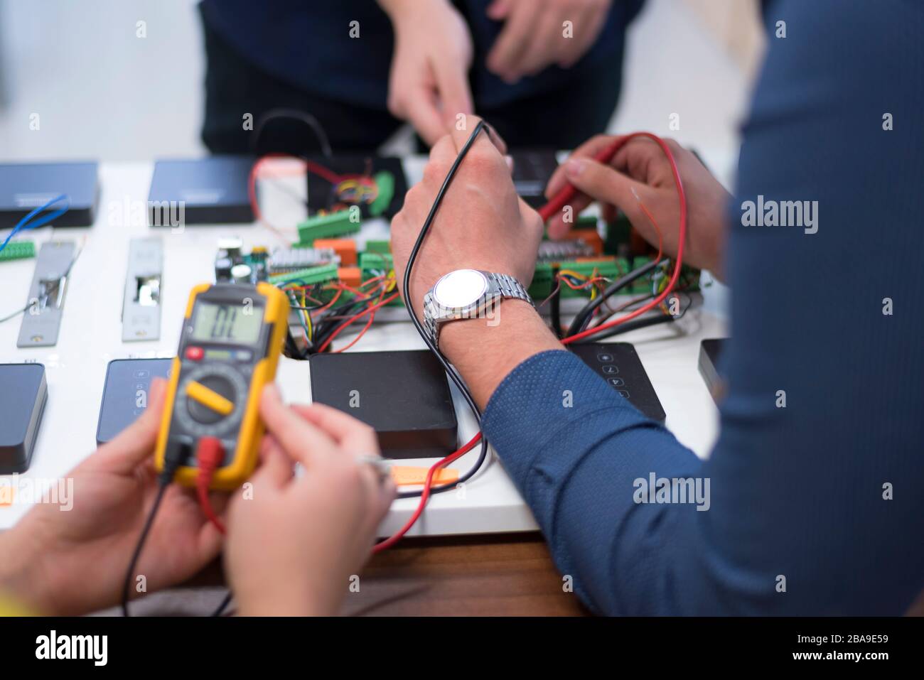 Two young handsome engineers working on electronics components.Tech tests electronic equipment in service center. Technologically Advanced Scientific Stock Photo