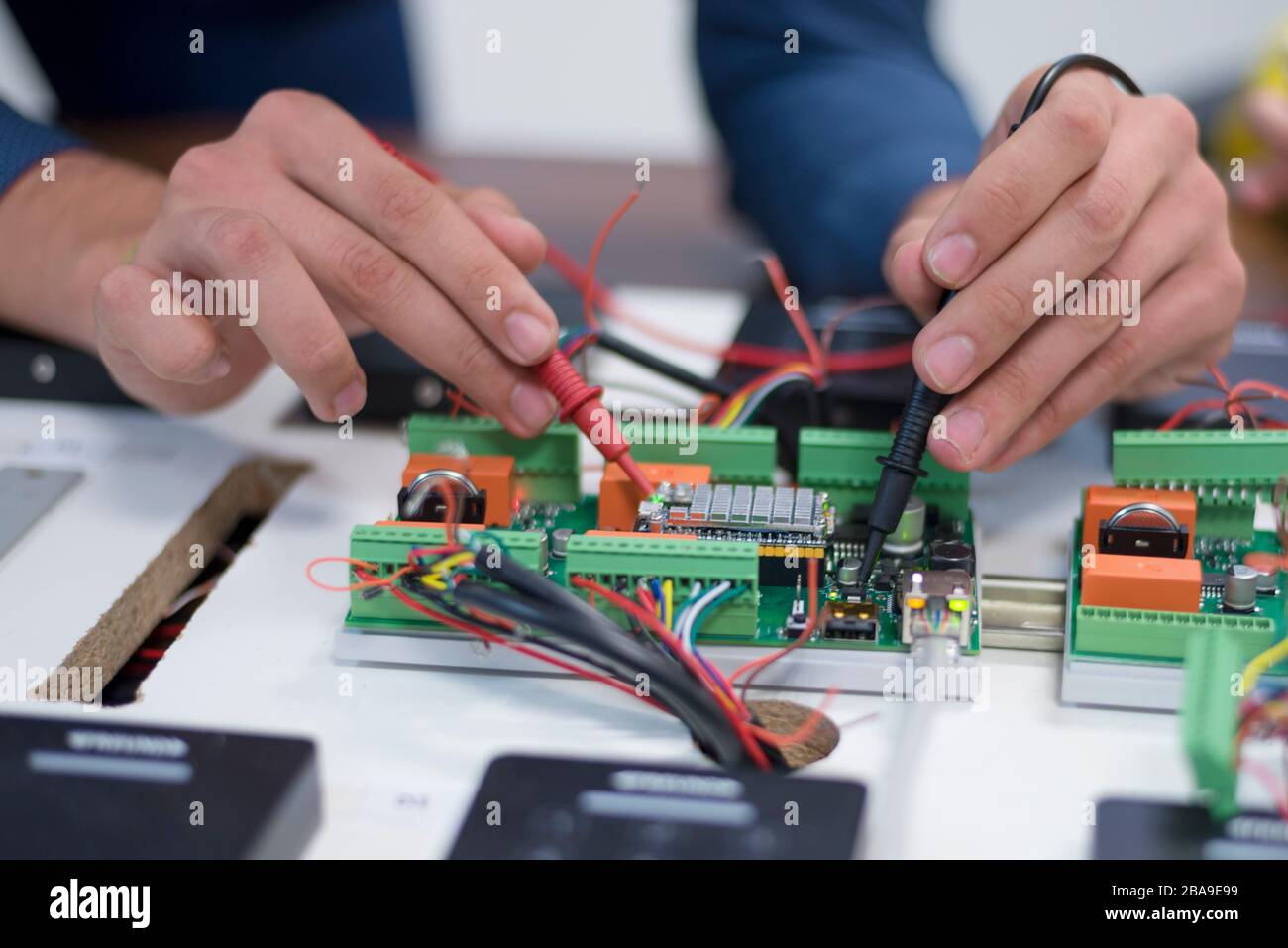 Two young handsome engineers working on electronics components.Tech tests electronic equipment