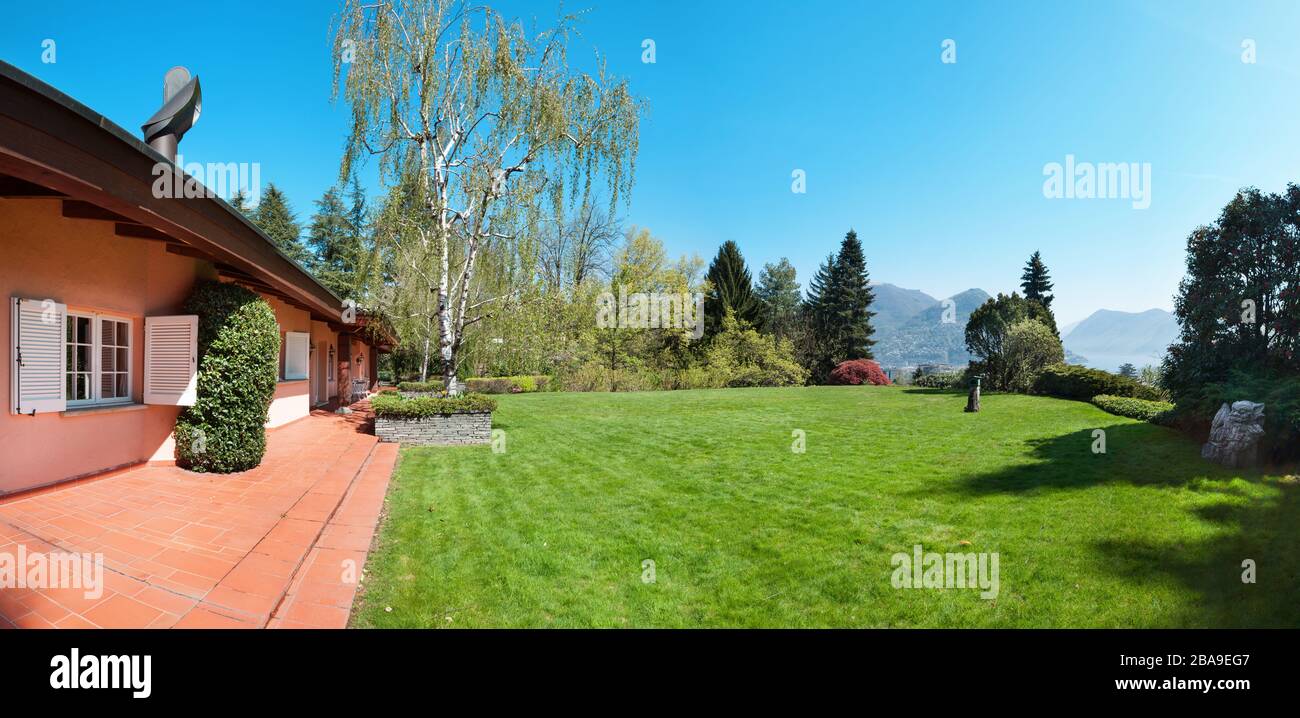 Green lawn and beautiful house in a sunny spring day Stock Photo - Alamy