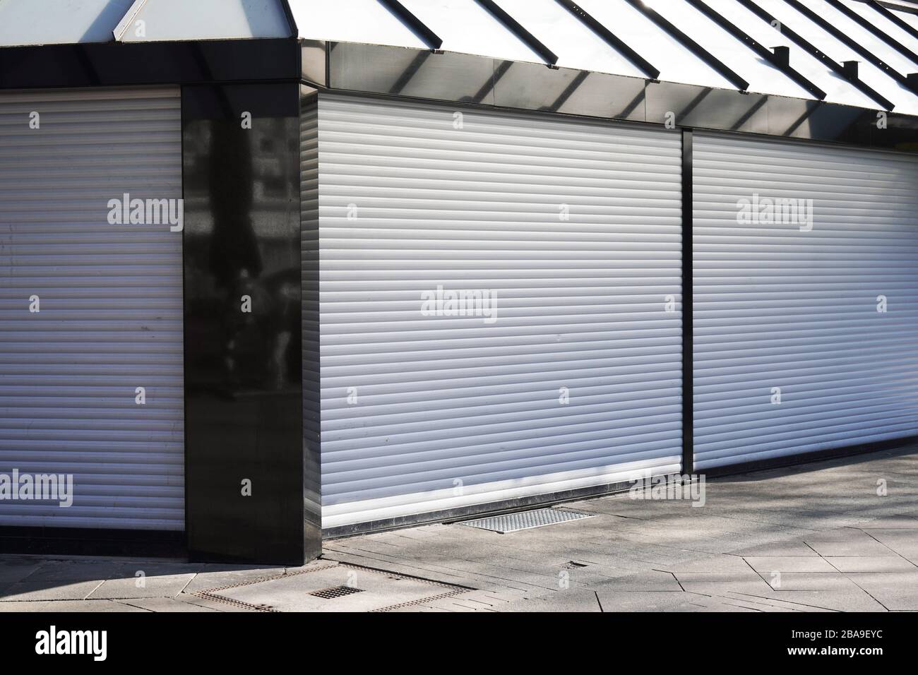closed business shop or store front with roller shutters - economy crisis and recession concept Stock Photo