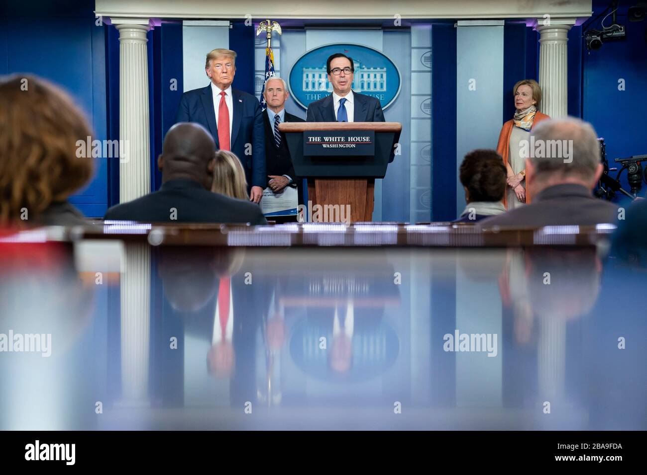 Washington, United States Of America. 25th Mar, 2020. Washington, United States of America. 25 March, 2020. U.S Secretary of the Treasury Steven Mnuchin, joined by President Donald Trump and Vice President Mike Pence, addresses remarks on the stimulus package at the Coronavirus Task Force briefing in the Press Briefing Room of the White House March 25, 2020 in Washington, DC. Credit: Tia Dufour/White House Photo/Alamy Live News Stock Photo