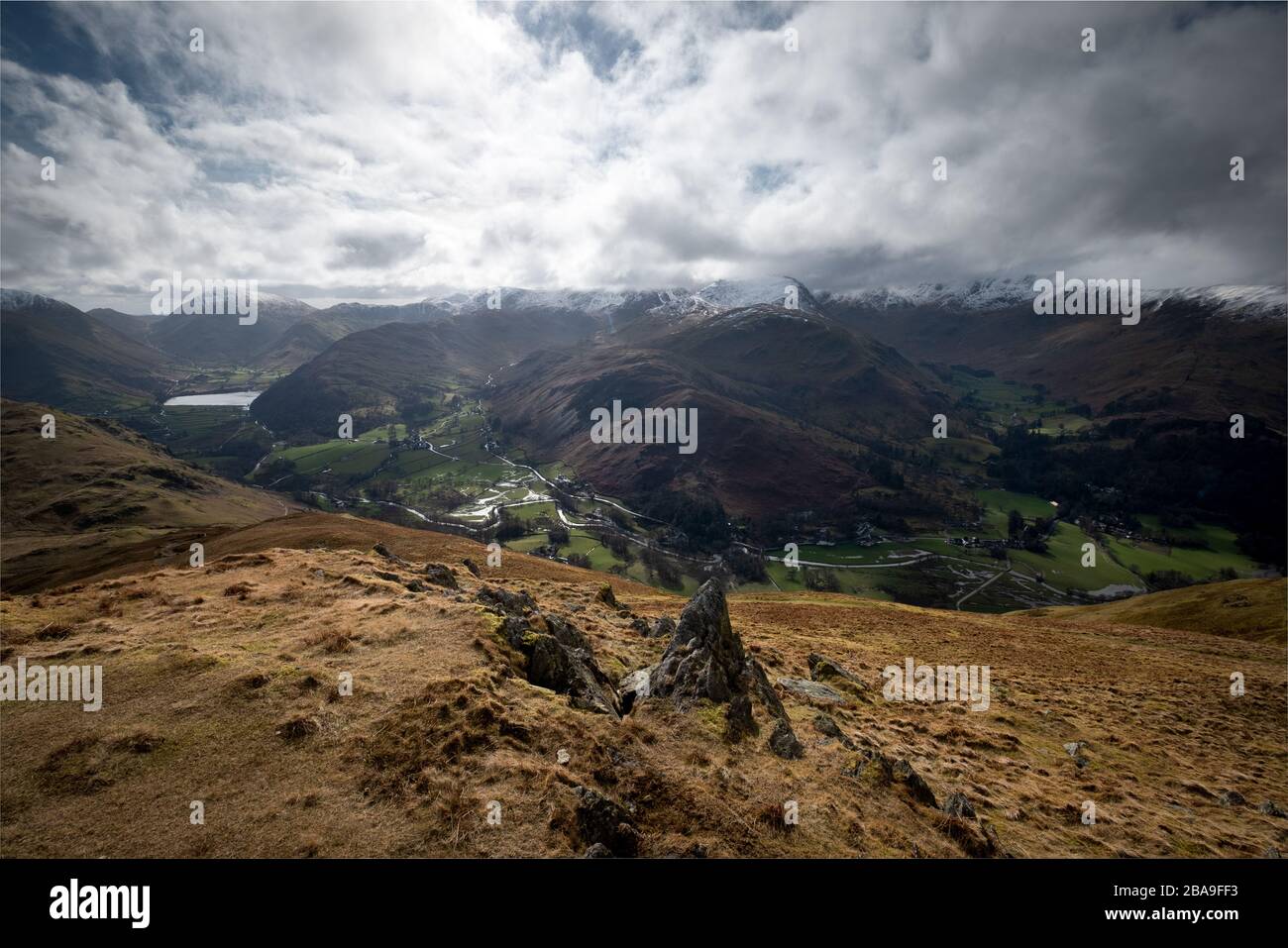 The snow covered summits of the Helvellyn Range above Patterdale, from the descent of Place Fell, Lake District, UK Stock Photo