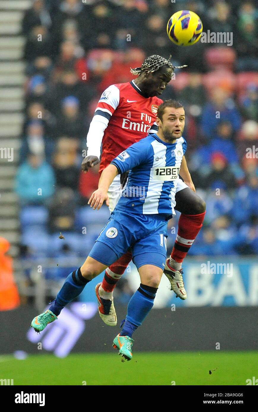 Wigan Athletic's Shaun Maloney (front) and Arsenal's Bacary Sagna (back) battle for the ball Stock Photo