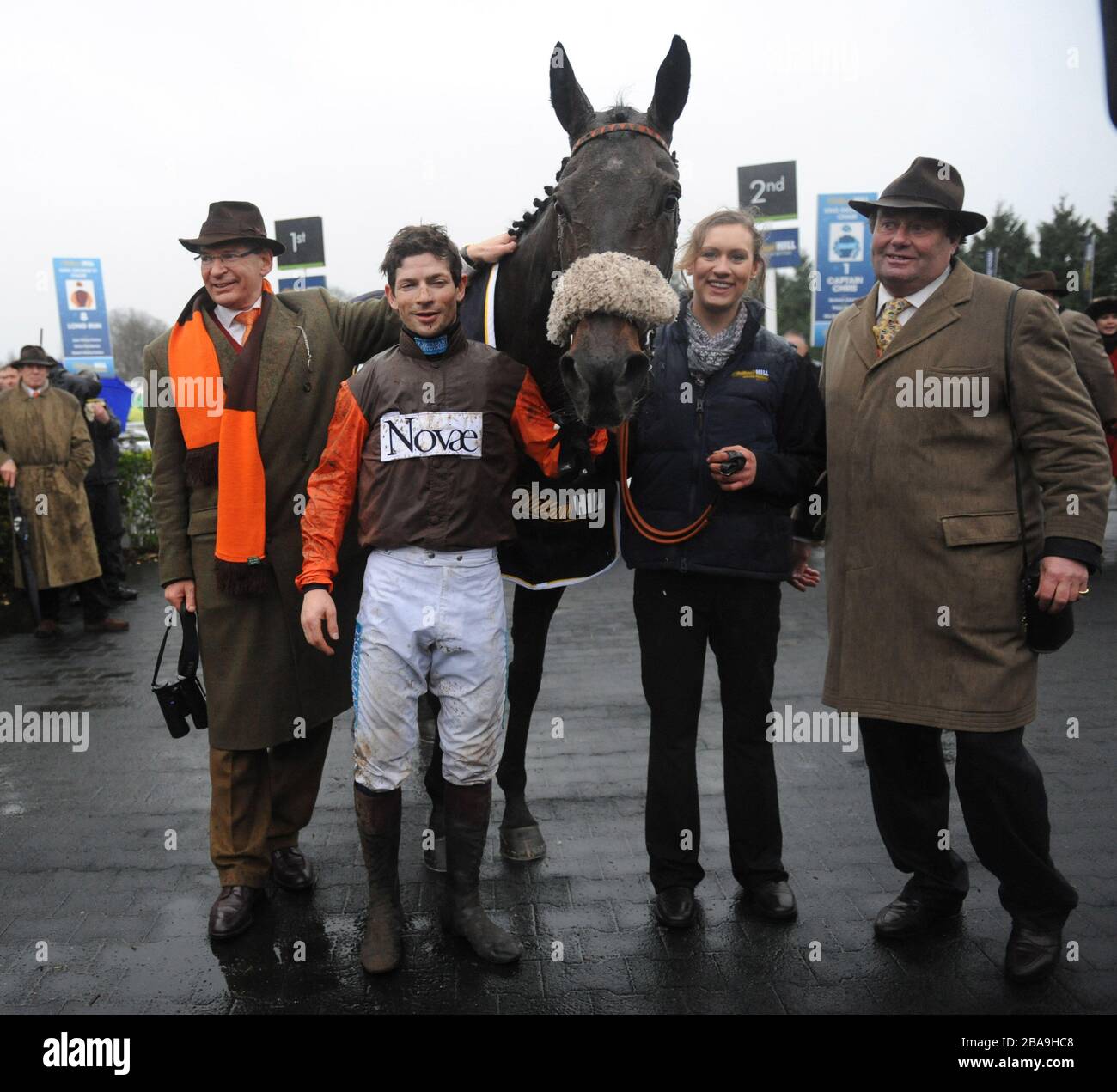 Robert Waley-Cohen, (owner), Sam Waley-Cohen (jockey), Long Run and trainer Nicky Henderson in the winners enclosure after winning a dramatic William Hill King George VI Chase Stock Photo