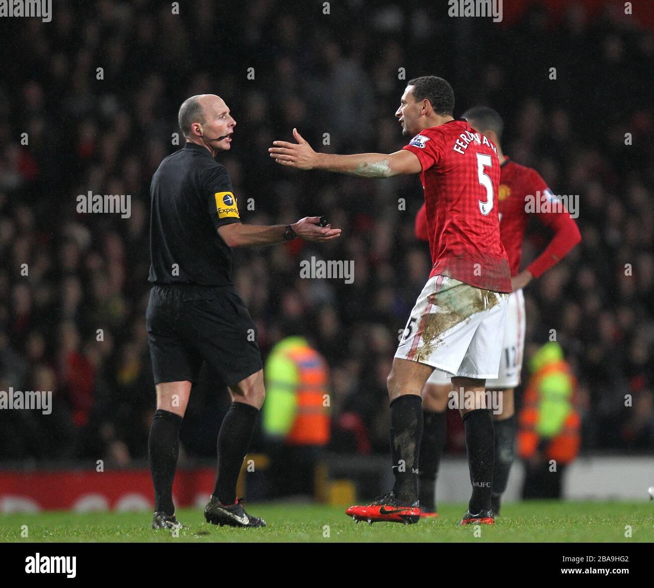 Manchester United's Rio Ferdinand (right) complains to referee Mike Dean (left) Stock Photo
