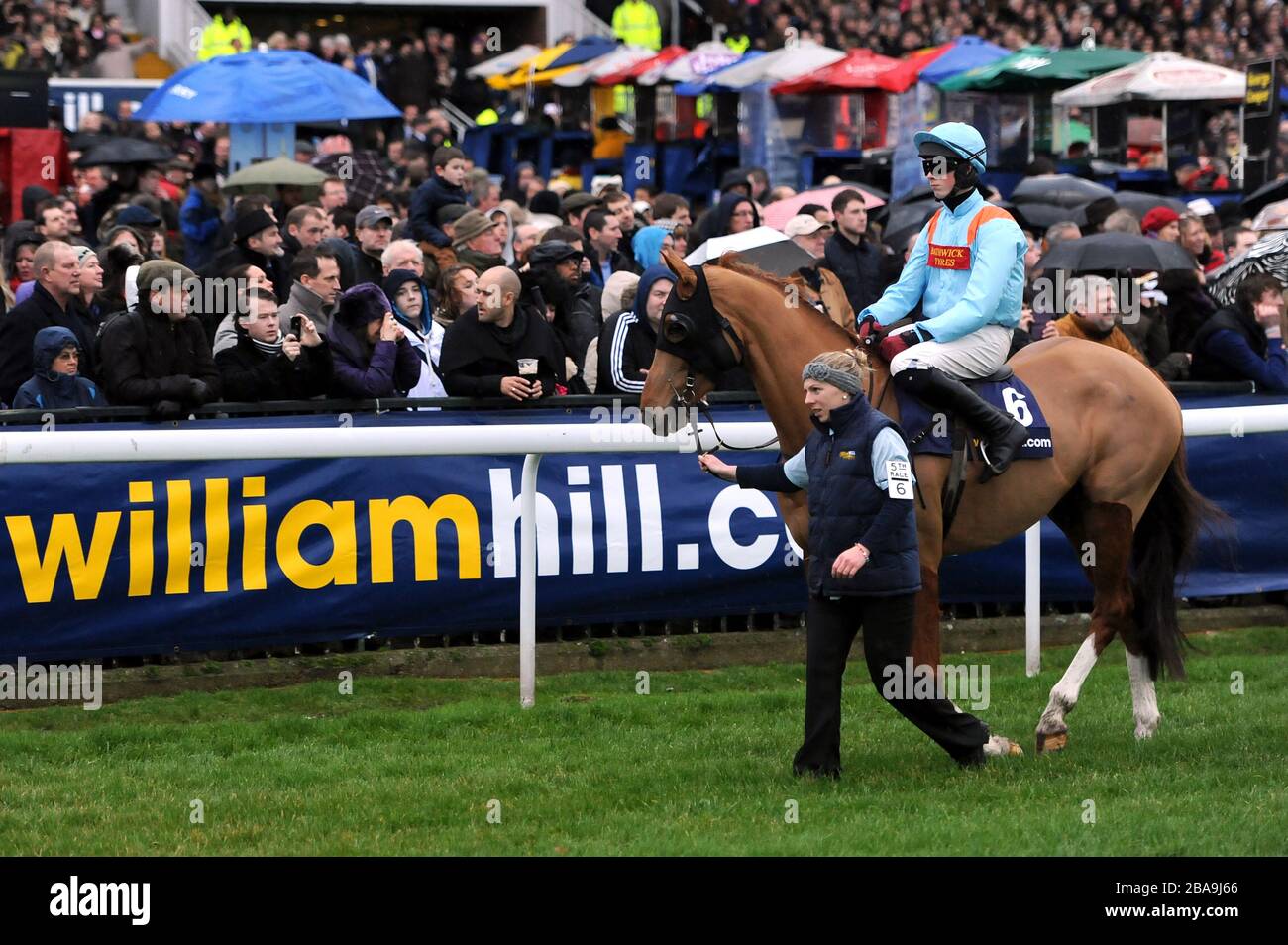 Junior ridden by Conor O'Farrell is paraded in front of the stands before the start of the William Hill King George VI Chase Stock Photo