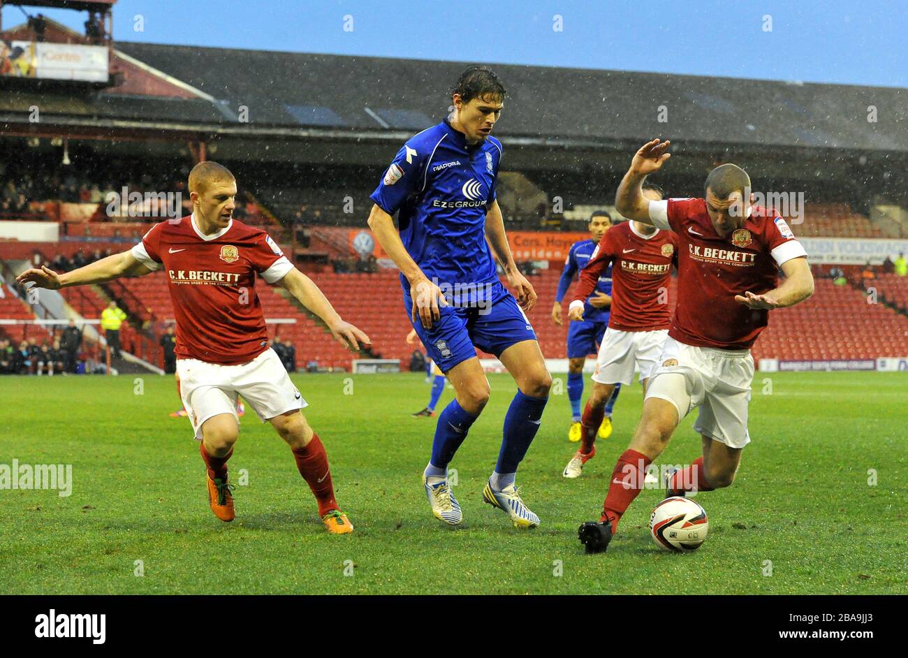 Birmingham City's Nikola Zigic (centre) in action with Barnsley's Bobby Hassell (left) and Stephen Dawson Stock Photo
