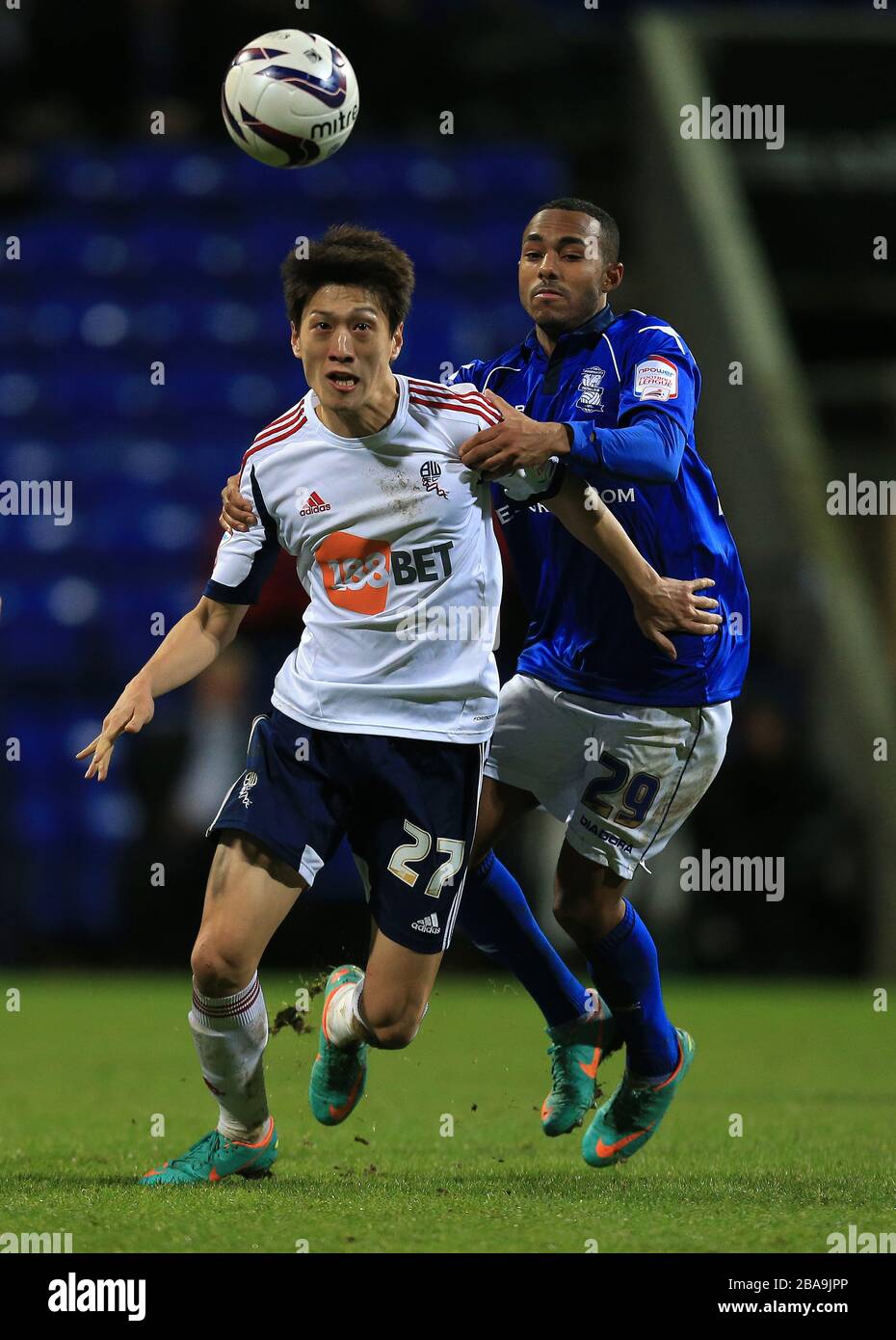 Bolton Wanderers' C.Y Lee (left) and Birmingham City's Robbie Hall (right) battle for the ball Stock Photo