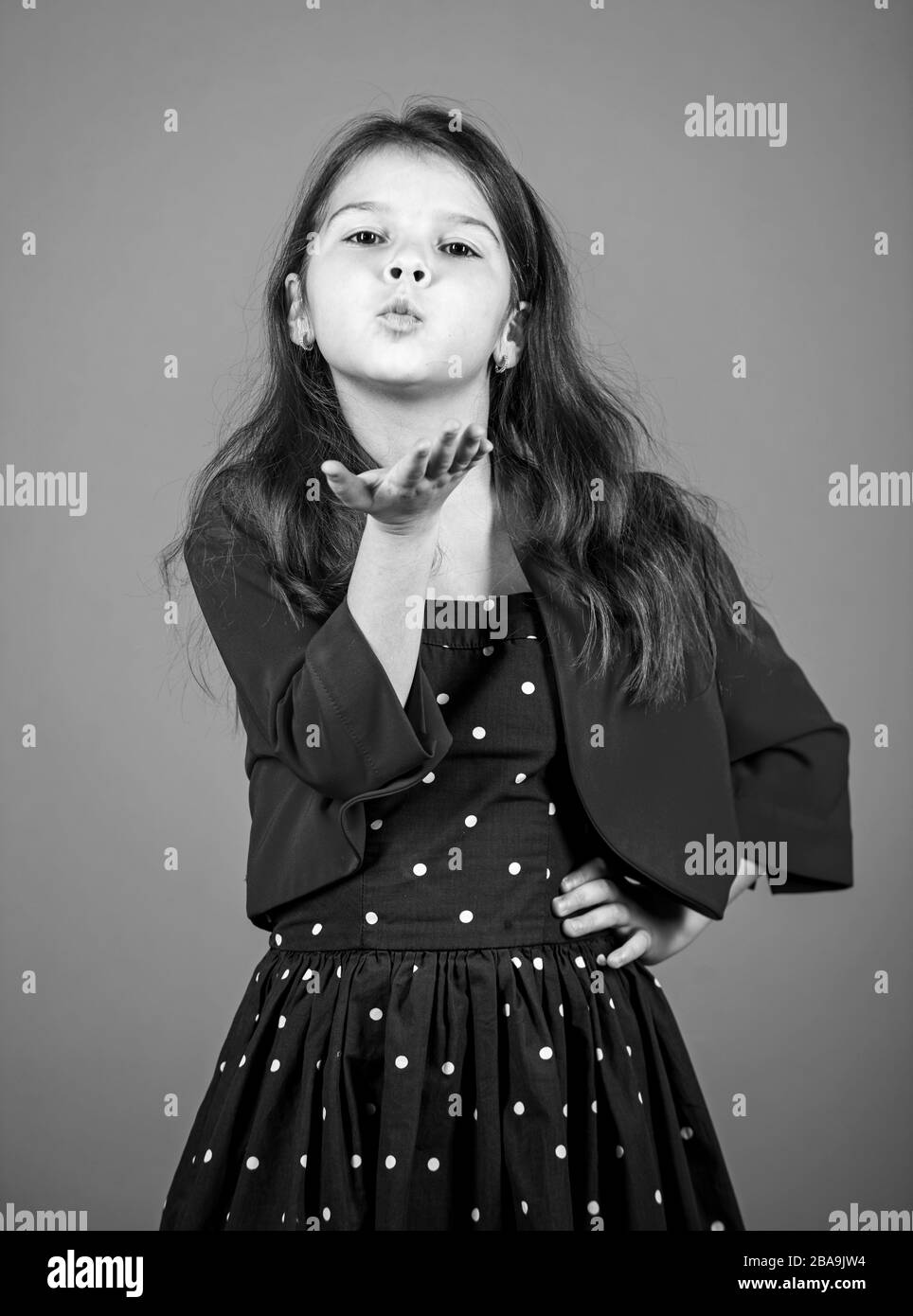 Air kissing. Little child send air kiss. Small girl in fashion style. Style and fashion. Keep elegance in style. Fashion style for festive days. Beauty salon. Stock Photo