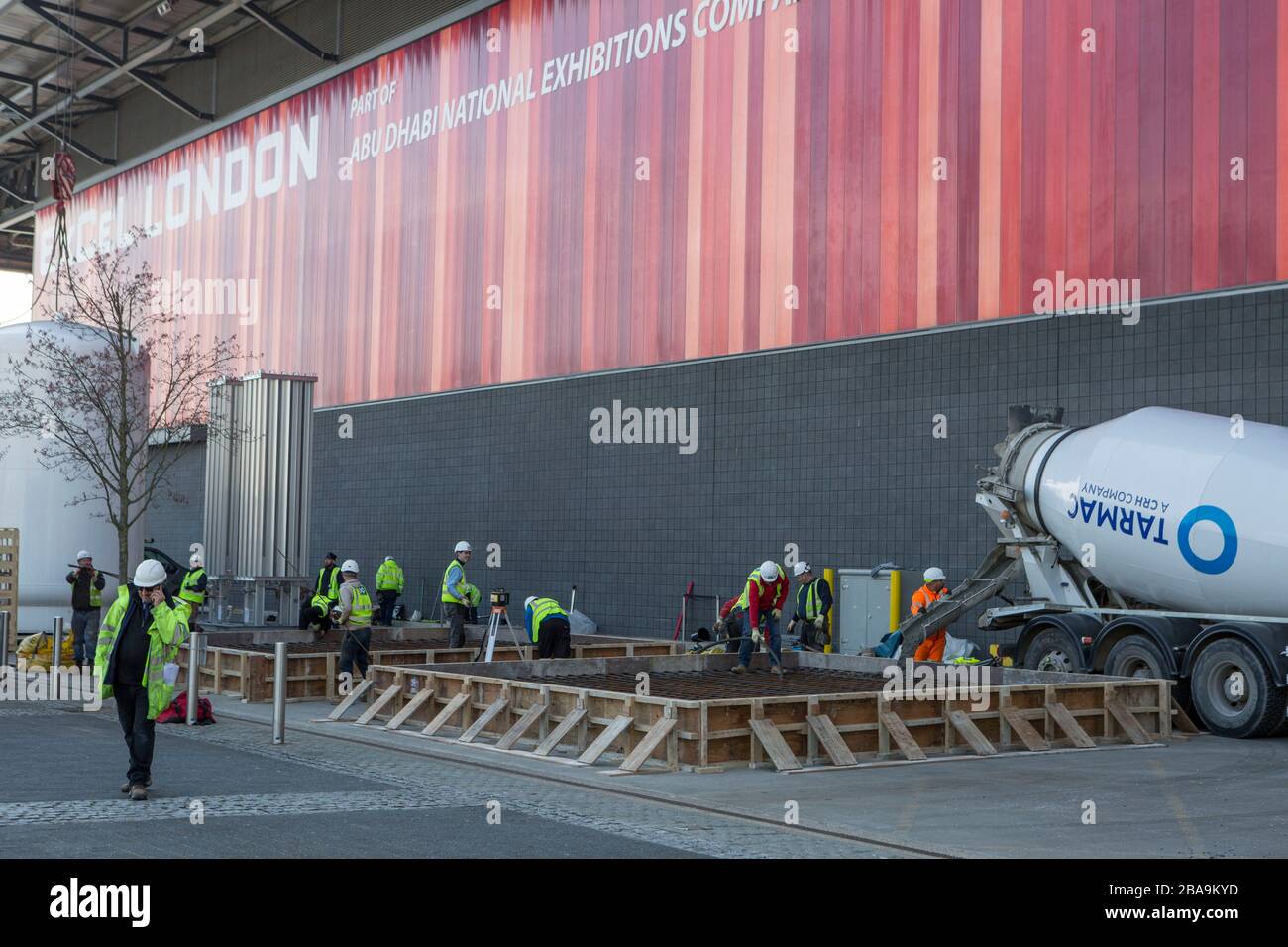 ExCel Centre, London, UK. 26th March 2020.  London ExCel is preparing a temporary hospital, an exhibition centre in east London, with a capacity to hold up to 4,000 patients.  Workers lay the foundations for 15-meter liquid oxygen containers. Stock Photo