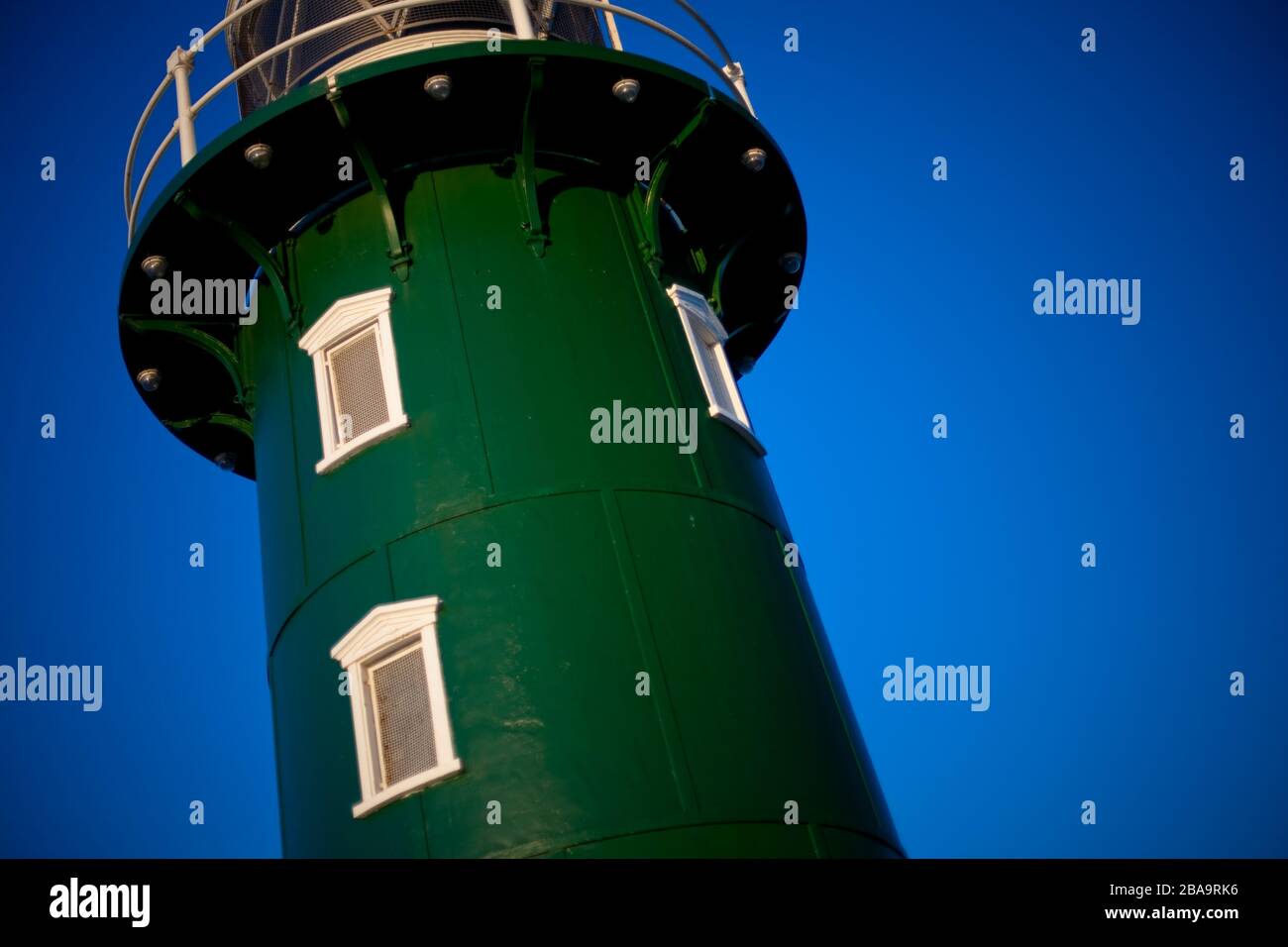 The green painted South Mole Lighthouse, in Fremantle bay, Western Australia at sunset Stock Photo