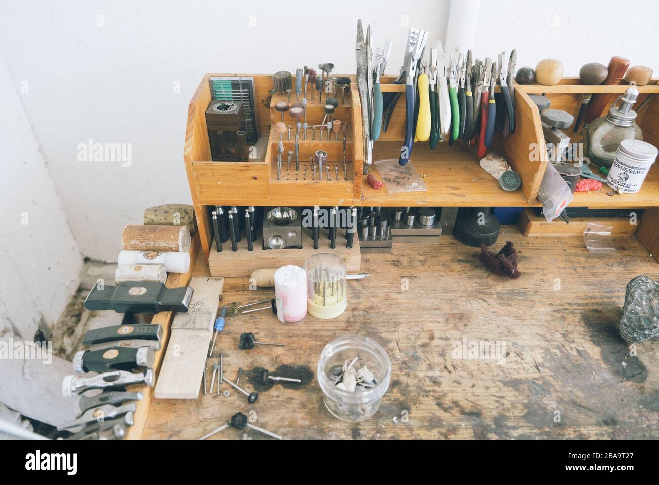 Overhead shot of wooden workbench with assorted tools and materials Stock Photo