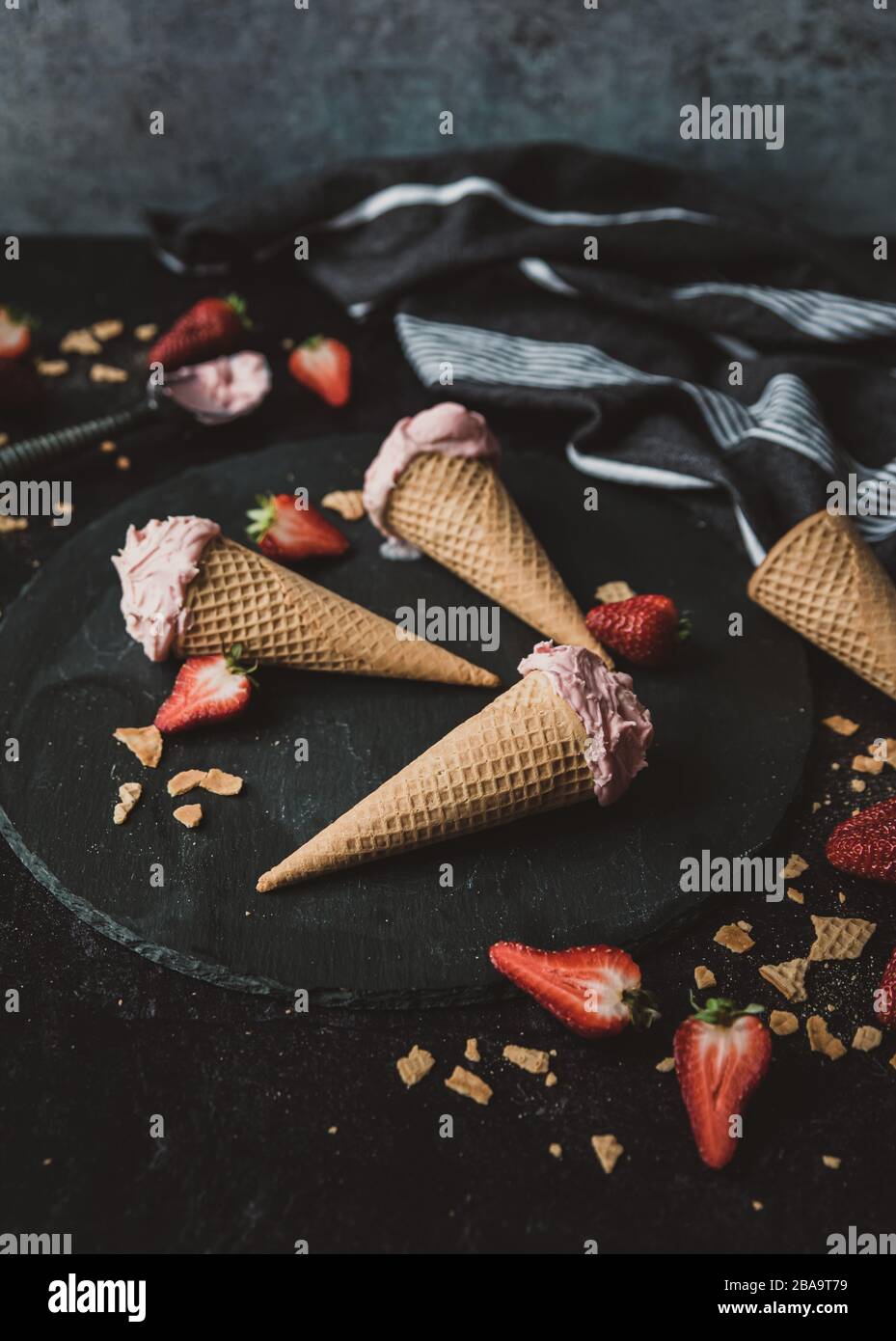 Close up of strawberry ice cream cones on a black background. Stock Photo