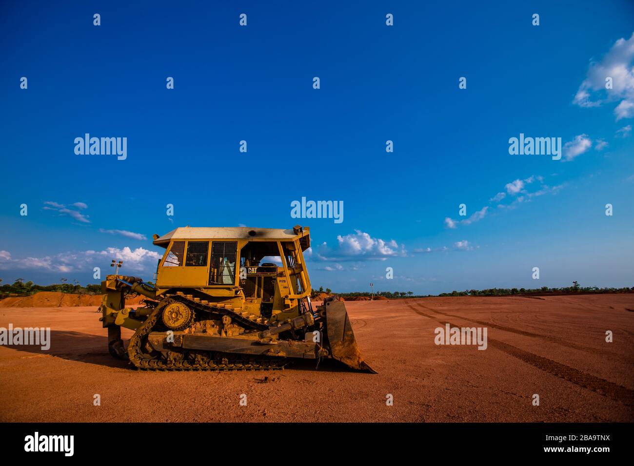 A huge bulldozer waiting at a strip mining bauxite, Far North Queensland Stock Photo