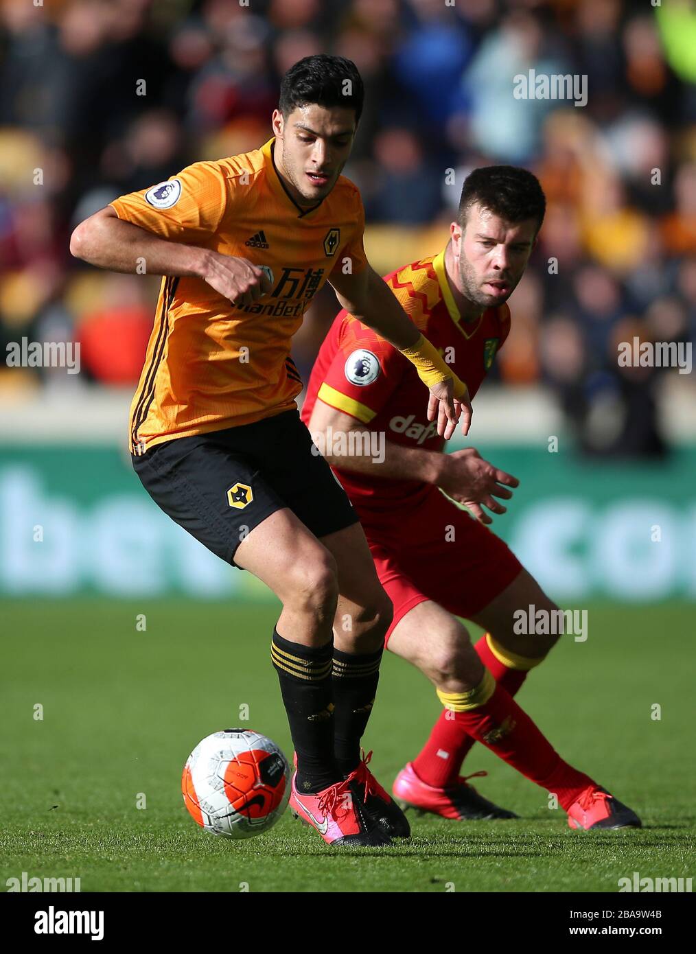 Wolverhampton Wanderers' Raul Jimenez (left) and Norwich City's Grant Hanley battle for the ball Stock Photo