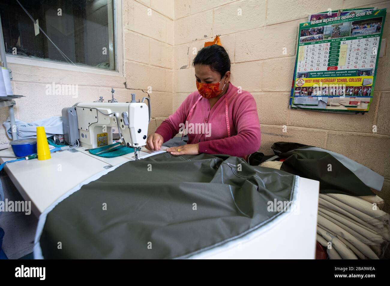 A hospital staff making the protective suit.Patan Hospital manufactures PPE suits (Production of Personal protective equipment) during the lock down imposed by the government amid concerns about the spread of corona virus disease (COVID-19) outbreak. The hospital is currently manufacturing approximately 8 PPE suit per day. Stock Photo