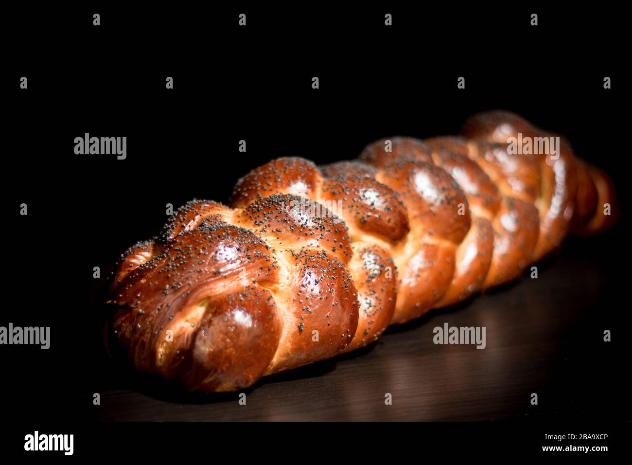 Braided Challah Bread Loaf with Poppy Seeds Against a Black Background Stock Photo Alamy