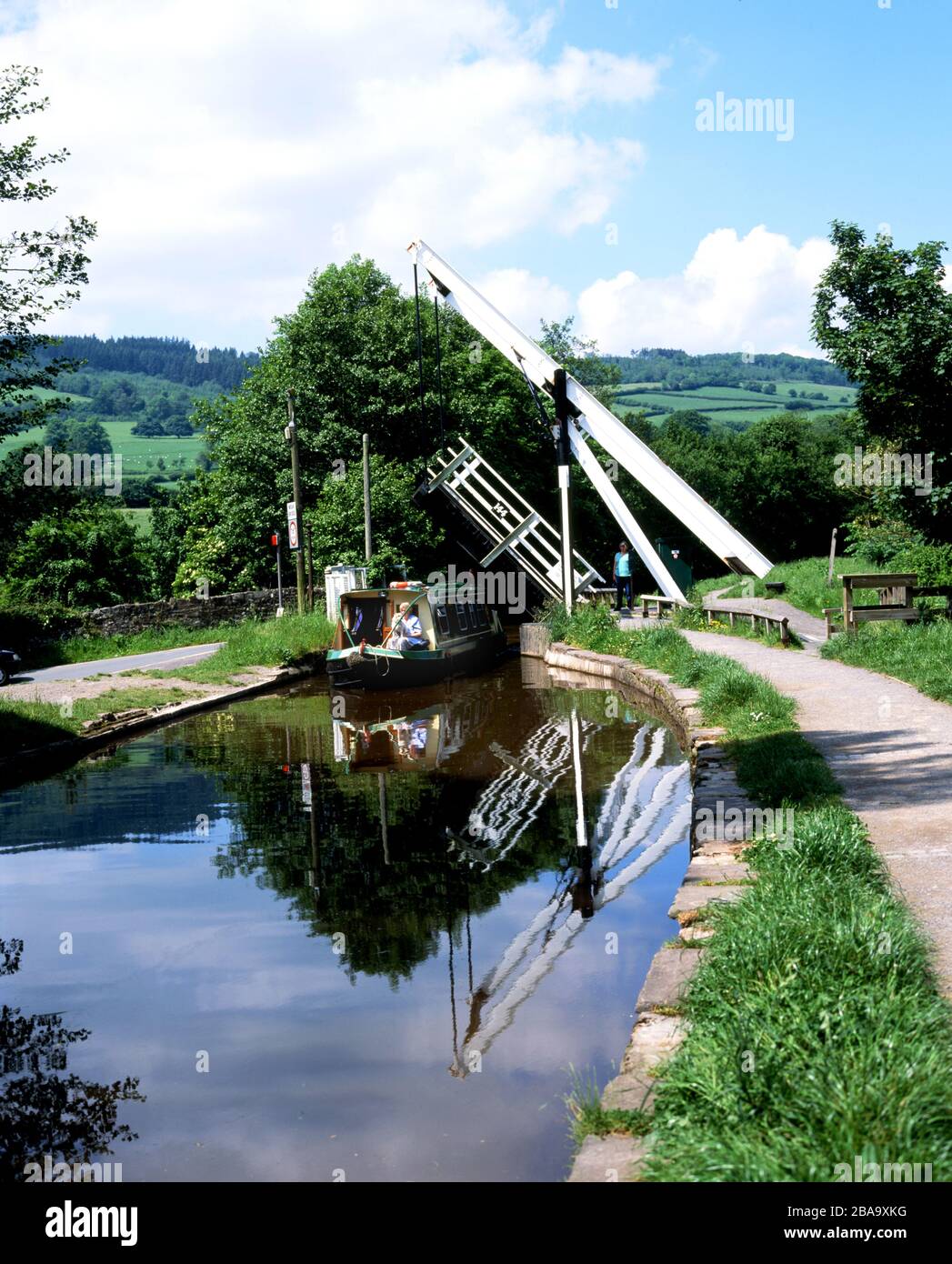 narrow boat going under lift bridge, monmouthshire & brecon canal, talybont on usk, powys. Stock Photo