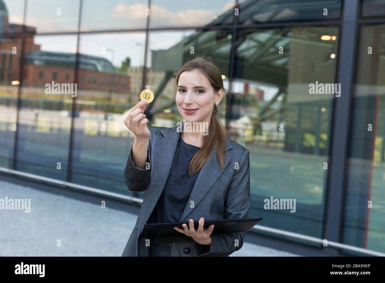The young beautiful woman holds bitcoin in a hand. She is a business lady  and invested her money in cryptocurrency, planning to make good money on it  Stock Photo - Alamy