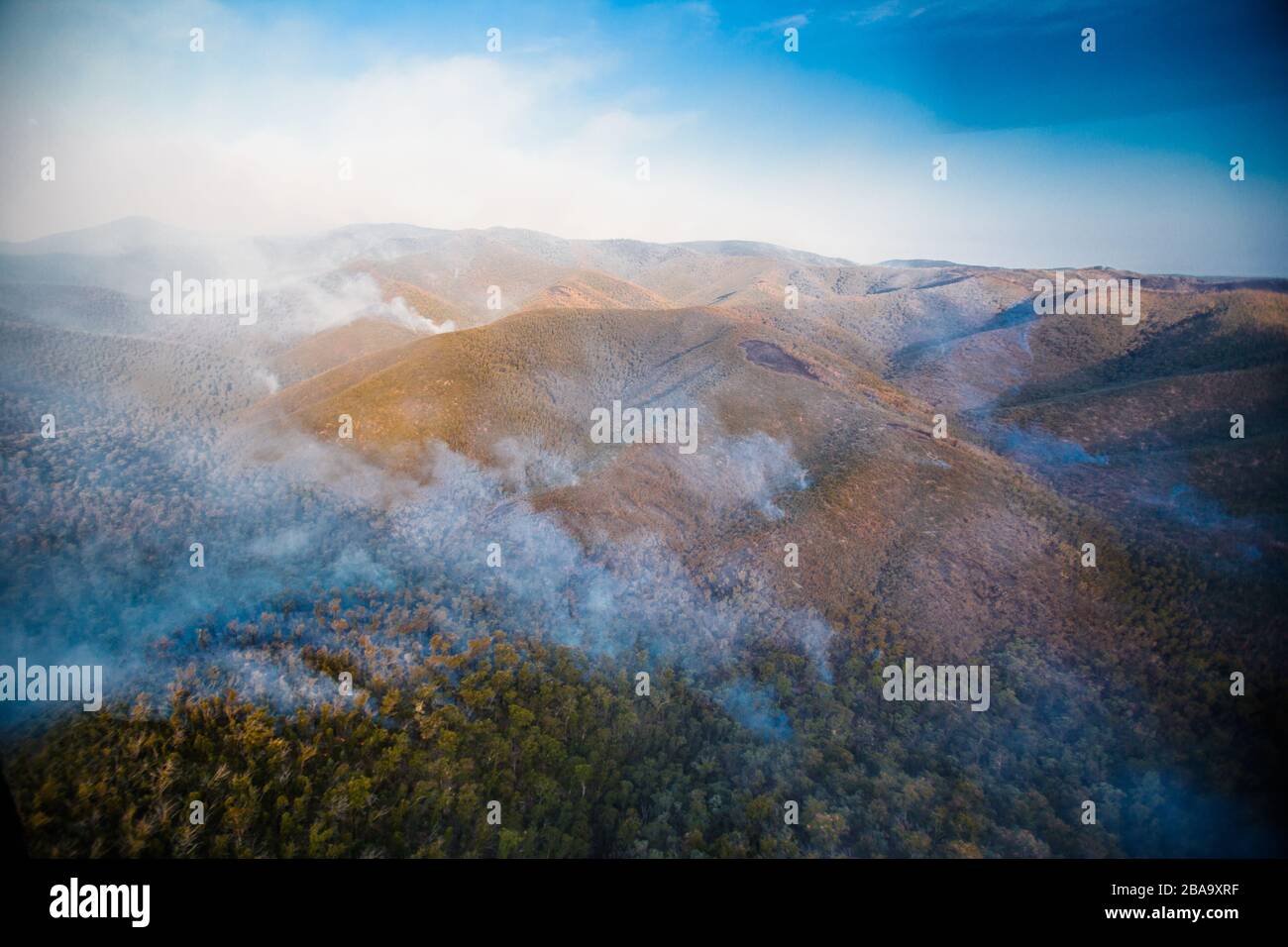 Flames and smoke cover an Australia wilderness mountain during bushfire season.  Victoria, Australia Stock Photo