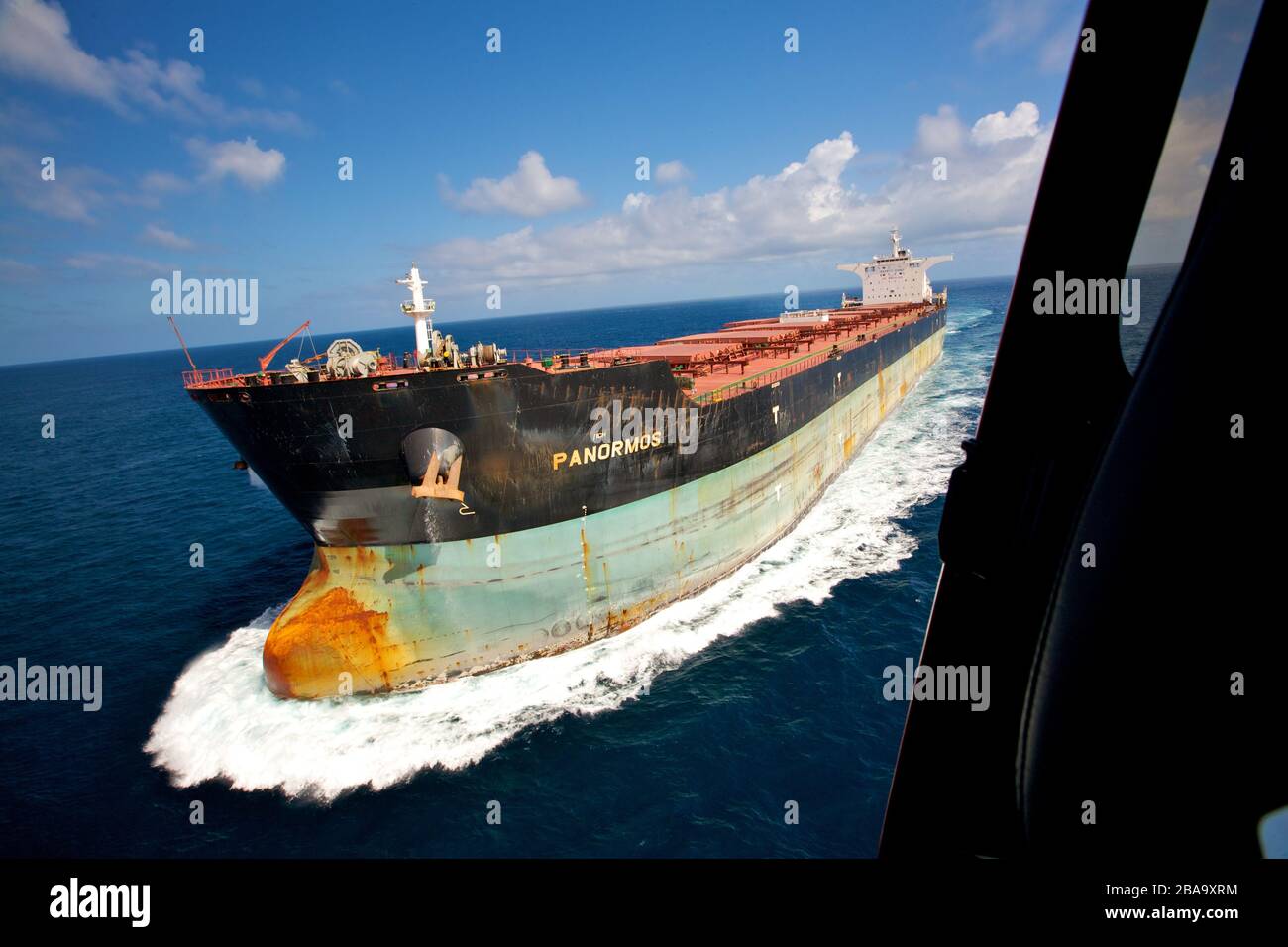 The bulk carrier Panormos travelling in the Great Barrier Reef, Australia. Stock Photo