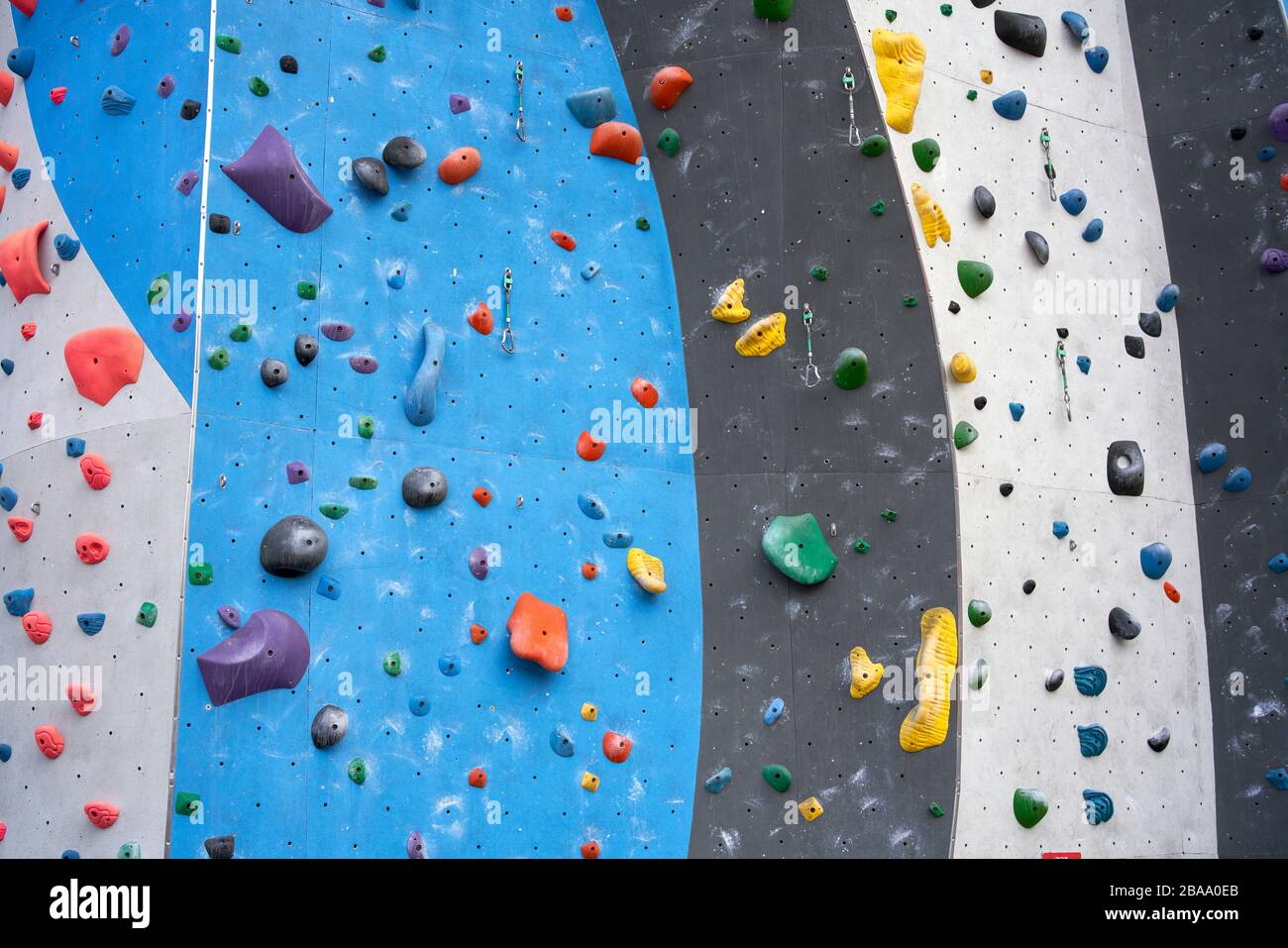 Climbing wall with colorful grips and holds Stock Photo
