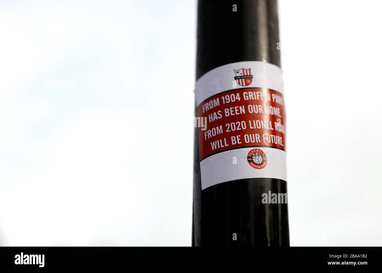A sticker on a post outside the ground that reads ‘From 1904 Griffin Park has been our home, from 2020 Lionel Road will be our home’ Stock Photo
