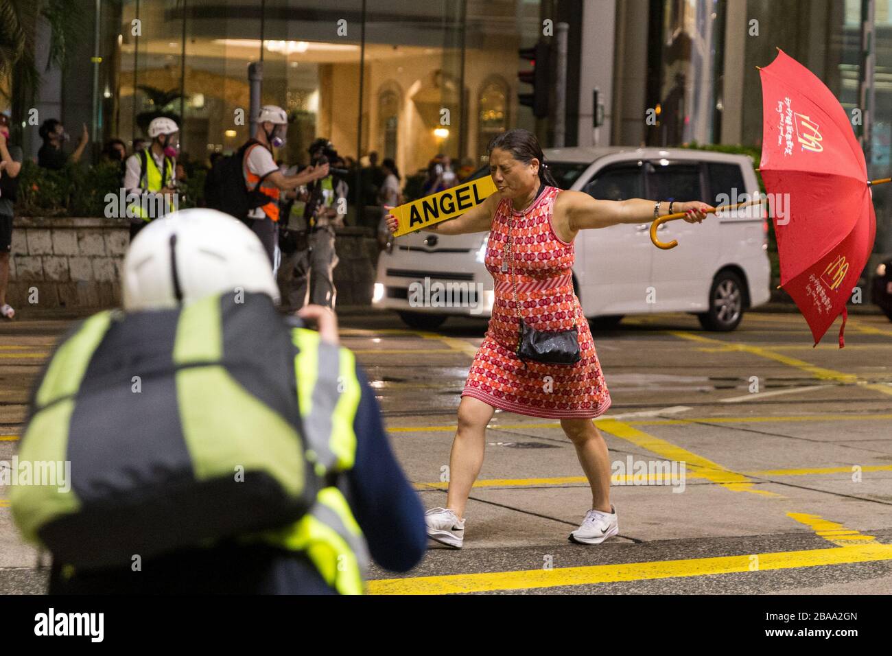 Girl with umbrella charging at police at the Hong Kong Protest, National Day 01.10.2019 Stock Photo
