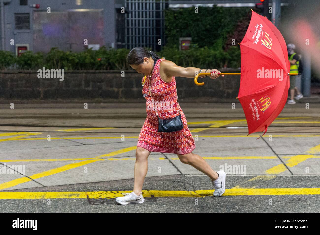 Girl with umbrella charging at police at the Hong Kong Protest, National Day 01.10.2019 Stock Photo